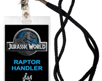 May include: A black and blue plastic ID badge with a Jurassic World logo, the text "Raptor Handler", and a barcode. The badge is attached to a black lanyard with a silver clip.