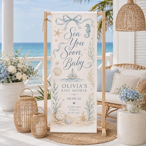 May include: A vertical rectangular banner featuring the text Sea You Soon, Baby, Olivia's Baby Shower, and 08.08.26. The design includes illustrations of a blue ribbon bow, a seahorse, a sailboat, seashells, starfish, and seaweed on a sandy base.