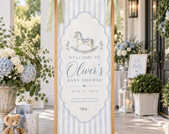 May include: A vertical rectangular banner with light blue and white vertical stripes, held by a wooden frame with sage green ribbons. It features a rocking horse illustration, the text "WELCOME TO Oliver's BABY SHOWER JUNE 14, 2025", and address details.