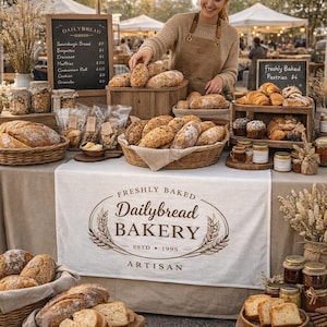 May include: A bakery display featuring various breads and pastries. Baskets and wooden crates hold loaves, rolls, and croissants. A sign reads "Dailybread Bakery" and lists menu items. Jars of preserves and decorative wheat stalks complete the scene.