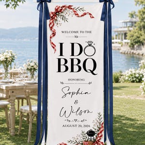 May include: A vertical white fabric banner featuring the text "WELCOME TO THE I DO BBQ HONORING Sophia & Wilson AUGUST 20, 2026". The design includes a diamond ring icon, a grill illustration, red gingham ribbons, and floral accents, suspended by dark blue ribbons.