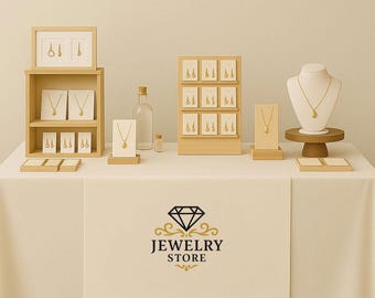 May include: A display of gold jewelry, including necklaces and earrings, arranged on wooden stands and in a wooden display case. The jewelry is presented on a white table with a "Jewelry Store" logo.