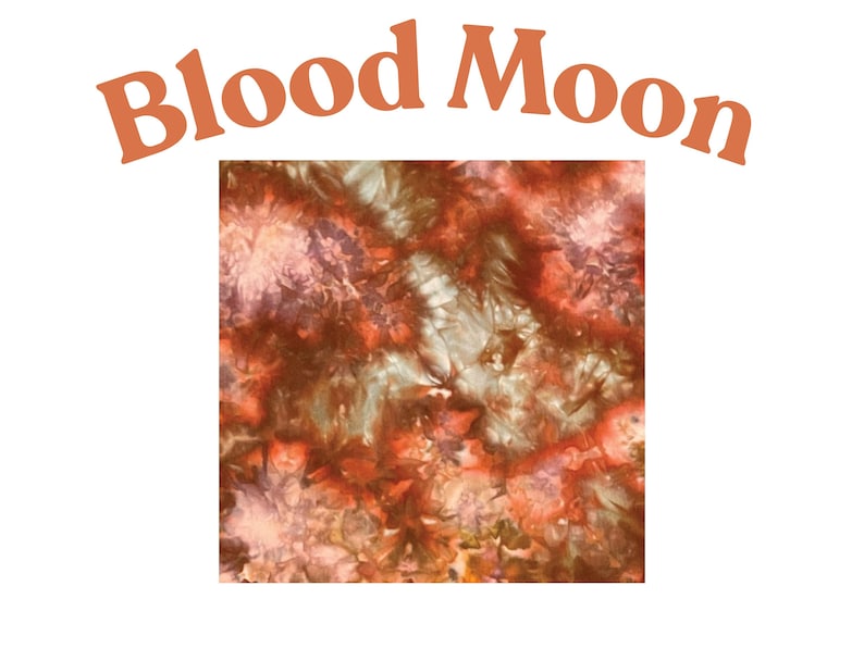 May include: A square fabric swatch featuring a tie-dye pattern in shades of deep red, burnt orange, and muted brown. The text "Blood Moon" is printed in a curved, bold, orange font above the square pattern, creating a celestial-inspired design.