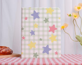 May include: A rectangular case with a pastel green and white checkered pattern, adorned with colorful stars in pink, yellow, blue, and green. The case is set on a red and white checkered tablecloth, with flowers in the background.