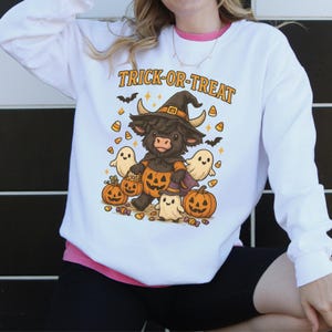Trick-or-Treat Highland Cow Sweatshirt, Halloween Cow with Pumpkin Tee, Fall Festive Cute Halloween Shirt, Spooky Sweatshirt for Fall, B256