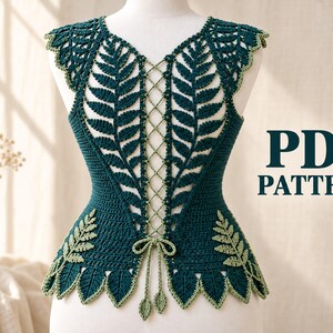 May include: A dark green crochet top featuring a lace-up front design with intricate fern leaf motifs and a scalloped hemline. The garment includes light green trim and a tie closure at the waist. The text PDF PATTERN is visible on the right side.