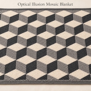May include: A square crochet blanket featuring an optical illusion pattern of three-dimensional cubes in shades of dark gray, light gray, and cream. The text Optical Illusion Mosaic Blanket is printed above the blanket.