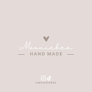 May include: A logo design on a light beige background. The word "Mooniebea" is written in a cursive font, with a small heart above it. Below, the words "HAND MADE" are centered. Social media icons and the username "@MOONIEBEA" are at the bottom.