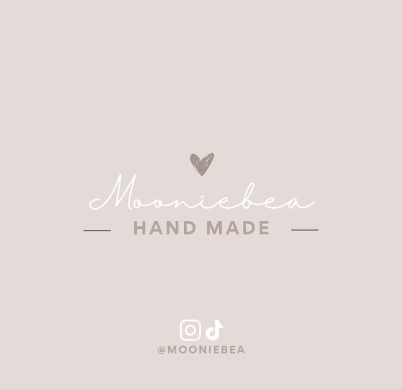 May include: A logo design on a light beige background. The word "Mooniebea" is written in a cursive font, with a small heart above it. Below, the words "HAND MADE" are centered. Social media icons and the username "@MOONIEBEA" are at the bottom.