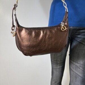 May include: A rustic wooden sign with the text "Welcome to our home" in white lettering. The sign features a distressed finish and a simple, inviting design, perfect for entryway decor.