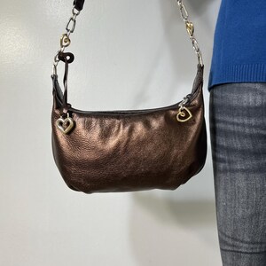 May include: A rustic wooden sign with the text "Welcome to our home" in white lettering. The sign features a distressed finish and a simple, inviting design, perfect for front door decor.