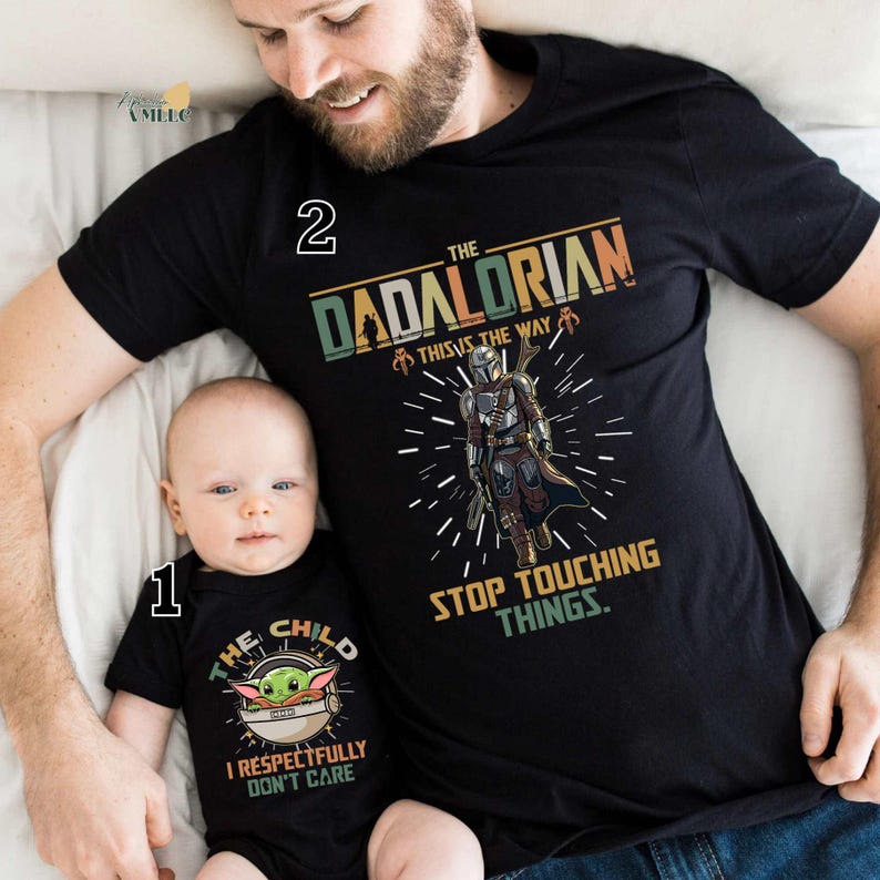 A man and a baby wearing matching t-shirts with a graphic design featuring a character from the Star Wars franchise.