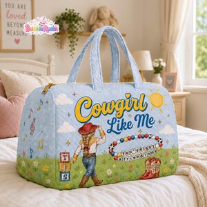 May include: A light blue quilted duffel bag featuring a graphic of a person in a cowboy hat, the text "Cowgirl Like Me," a beaded bracelet with the text "You've got a friend in me," musical notes, clouds, flowers, and stacked alphabet blocks.