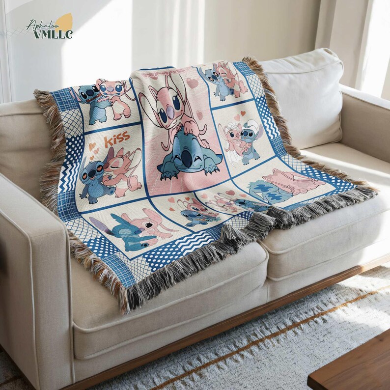 a cozy living room setting with a white couch and a colorful throw blanket with various cartoon characters on it.