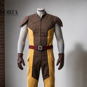 May include: A full-body costume featuring a brown and yellow jumpsuit with a front zip, shoulder pads, and cargo-style pockets. A maroon belt with a square buckle displaying an X symbol is worn at the waist. Brown leather gloves are included.