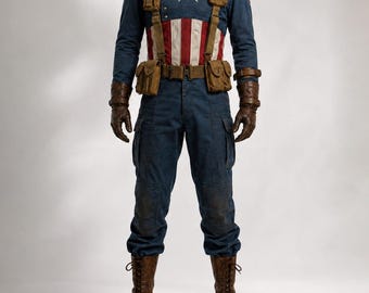 May include: A blue long-sleeve shirt with a white star and red and white vertical stripes on the torso, paired with blue cargo pants, brown leather gloves, brown lace-up boots, and a brown utility belt with pouches. The text GLORIA CUSTOM WEAR is visible.