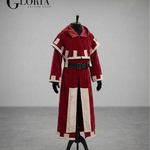 May include: A burgundy custom wear robe with cream-colored accents, a hood, and a black belt. The robe is displayed on a black mannequin. The text "GLORIA CUSTOM WEAR" is in the upper left corner.