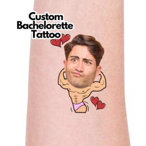 May include: A temporary tattoo featuring the text "Custom Bachelorette Tattoo" and a cartoon illustration of a man's face and muscular body. The cartoon has a pink speedo and red hearts.