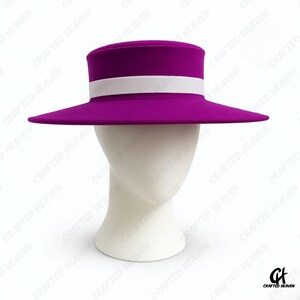 Elegant black felt top hat with wide brim and white satin band, inspired by Melania Trump’s inauguration style, displayed on white background