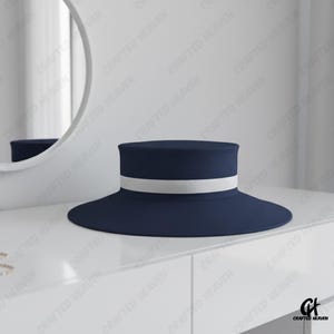 Elegant black felt top hat with wide brim and white satin band, inspired by Melania Trump’s inauguration style, displayed on white background