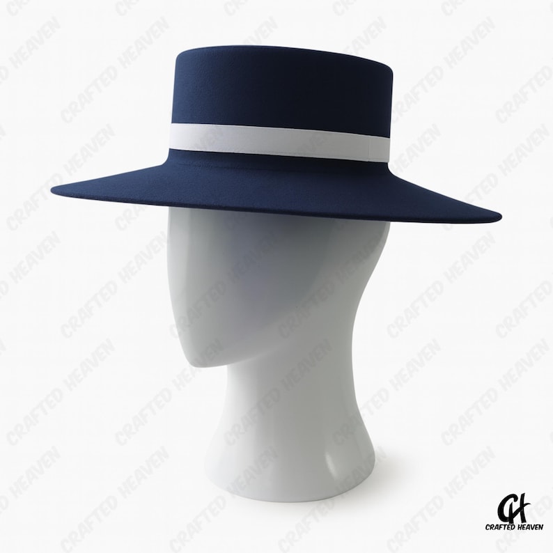 Elegant black felt top hat with wide brim and white satin band, inspired by Melania Trump’s inauguration style, displayed on white background