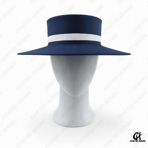 Elegant black felt top hat with wide brim and white satin band, inspired by Melania Trump’s inauguration style, displayed on white background