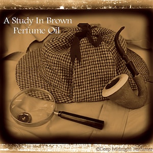May include: A brown and black tweed hat with a black ribbon, a magnifying glass, and a brown pipe. The text "A Study In Brown Perfume Oil" is visible in the image.
