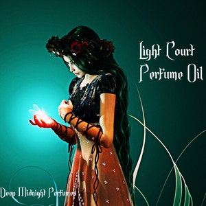 Peut inclure: Illustration numérique d'une femme aux longs cheveux noirs et à une couronne florale, vêtue d'une robe bleu foncé et orange. Elle tient une lumière brillante. Le texte indique "Light Court Perfume Oil" et "Deep Midnight Perfumes".