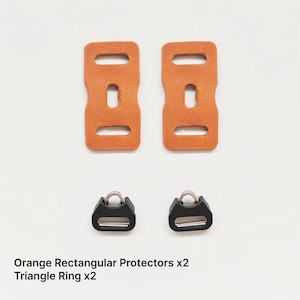 May include: Two orange rectangular protectors and two black triangle rings are displayed on a white background. The protectors are made of a textured material. The text in the image reads: Orange Rectangular Protectors x2, Triangle Ring x2.