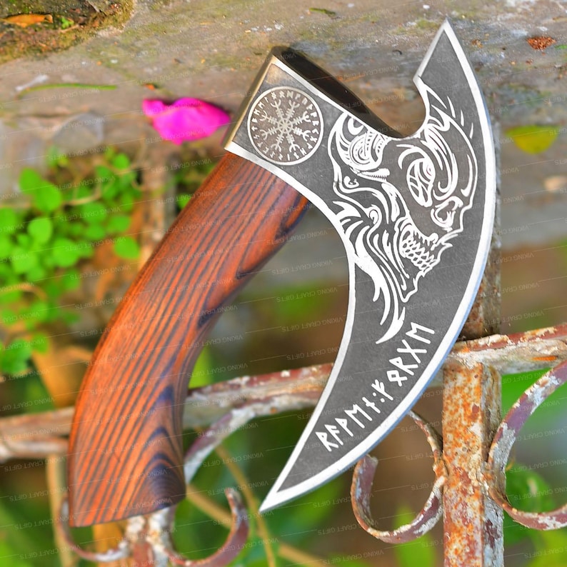 May include: A hand-crafted axe with a wooden handle and a steel head. The head is decorated with a skull and crossbones design and the text "R&Auml;PMIIK:RXM".