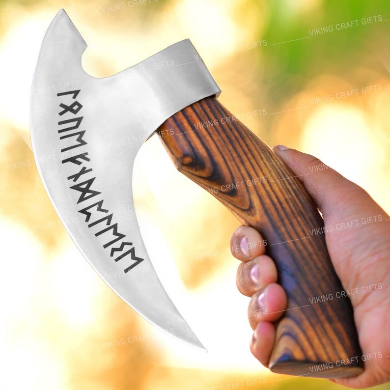 May include: A silver axe with a wooden handle. The axe head has a curved blade and a small hole in the top. The blade is engraved with a series of runes. The handle is made of dark wood with a grain pattern.