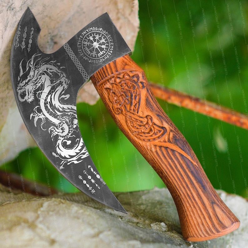 May include: A black axe with a wooden handle. The axe head has a dragon design and a circular design with runes. The handle is carved with a dragon design.