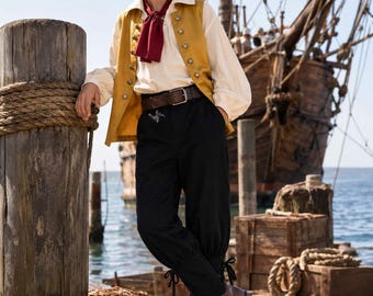 May include: A costume consisting of a mustard yellow vest with metallic buttons, a cream-colored long-sleeve shirt, a dark red neck scarf, a wide brown leather belt with a metal buckle, and black trousers featuring lace-up details at the ankles.