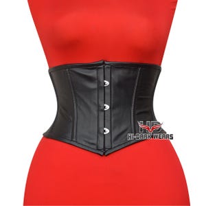 May include: A black faux leather corset with three silver clasps down the front. The corset is displayed on a red mannequin. The logo "HI-DARK WEARS" is visible on the lower right side of the corset.