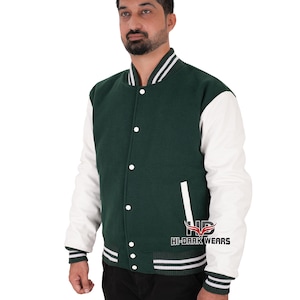 May include: A green and white varsity jacket with a button-up front. The jacket has white sleeves and a green body, with white and black striped details on the collar, cuffs, and hem. The text "HI-DARK WEARS" is visible on the jacket.