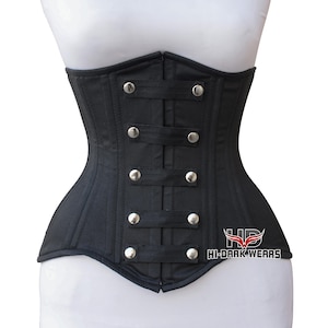 Puede incluir: Corsé negro con detalles de botones y correas plateadas. El diseño estructurado presenta costuras verticales y una forma curvada. La prenda se muestra en un maniquí blanco. La marca "HI-DARK WEARS" es visible.