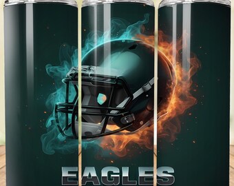 May include: A set of three stainless steel tumblers with a football theme. The design features a football helmet engulfed in blue and orange flames, with the word "EAGLES" in silver lettering. Each tumbler has a black lid and a straw.