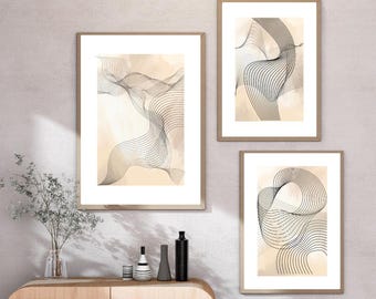 May include: Three framed abstract art prints. Each print features a unique design of black, wavy lines against a beige and light brown background. The frames are a light wood color, and the art is displayed on a neutral wall.