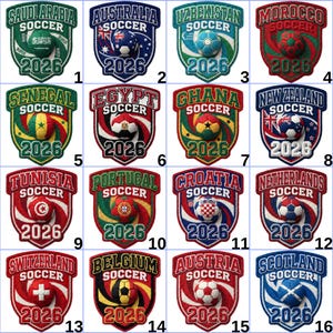 May include: Sixteen embroidered soccer patches, each with a country's name and a soccer ball. The patches are shield-shaped with the word "SOCCER" above and the year "2026" below. Each patch has a unique colour scheme and design.