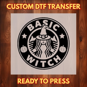 May include: A black and white circular graphic design featuring a central figure wearing a witch hat, surrounded by two pumpkins and stars. The text reads CUSTOM DTF TRANSFER at the top, BASIC WITCH in the center, and READY TO PRESS at the bottom.