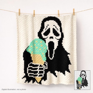 May include: A cream-colored, crocheted blanket featuring a black and white graphic of the Ghostface mask from the Scream movie franchise. The character is holding a mint green ice cream cone with yellow sprinkles. The blanket is hung with wooden clothespins.