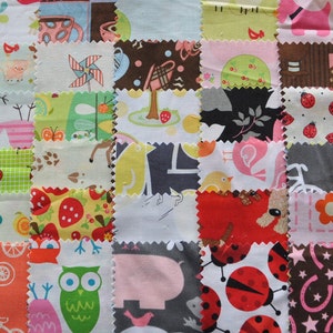 May include: A patchwork quilt made of colourful fabric squares with various patterns, including animals, flowers, and geometric designs. The quilt is made with a variety of fabrics, including cotton, linen, and silk.