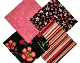May include: Four fabric squares in a variety of patterns. The squares are black with red, pink, and white floral patterns, stripes, and a solid pink pattern.
