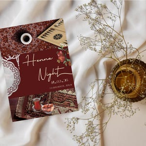 Puede incluir: Una invitación burdeos con las palabras "Henna Night" en escritura elegante, junto con una fecha y dirección. La invitación está sobre una tela blanca, con un jarrón decorativo y ramitas de flores blancas.