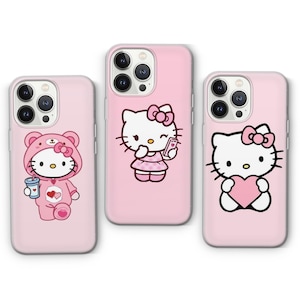 May include: Three pink iPhone cases featuring Hello Kitty designs. The cases showcase different Hello Kitty characters, including Hello Kitty holding a heart, Hello Kitty holding a phone, and Hello Kitty dressed as a bear.