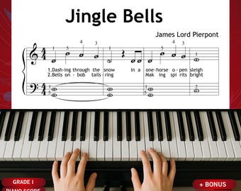 Puede incluir: Partitura de piano de "Jingle Bells" de James Lord Pierpont. La partitura se muestra sobre un fondo blanco con un borde rojo. Las teclas del piano son blancas y negras, y las manos de una persona están tocando el piano.