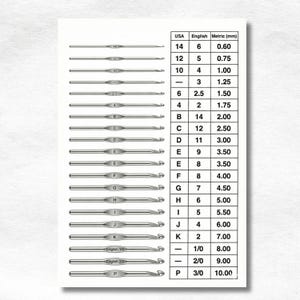 May include: A comprehensive crochet hook size conversion chart featuring a vertical list of silver-toned metal hooks aligned with a table. The table displays columns for USA, English, and Metric sizes in millimeters, ranging from 0.60 mm to 10.00 mm.