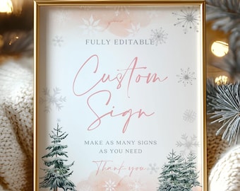 May include: A framed sign with a gold border, featuring the words "Custom Sign" in elegant script. The sign has a soft pink and white background with snowflake and Christmas tree illustrations. The text "Make as many signs as you need" is also included.