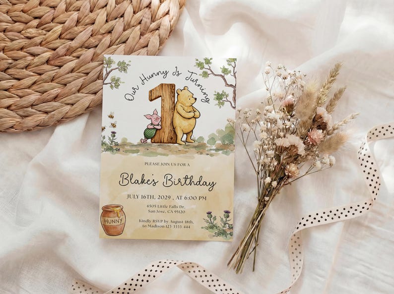 Watercolor illustration of a classic Winnie the Pooh and Piglet standing by a large wooden number one, featuring a honey pot, bees, and thistles on a soft yellow wash background.