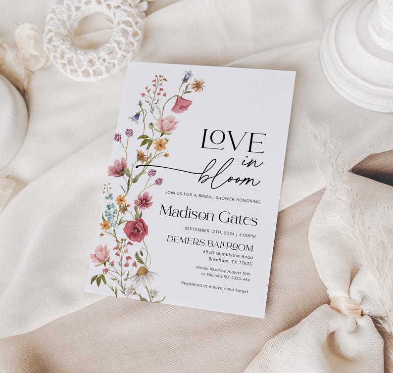 Editable bridal shower invitation template with romantic wildflower watercolor design, featuring soft pink, yellow, blue, and burgundy florals on a white background, paired with elegant serif and modern script fonts